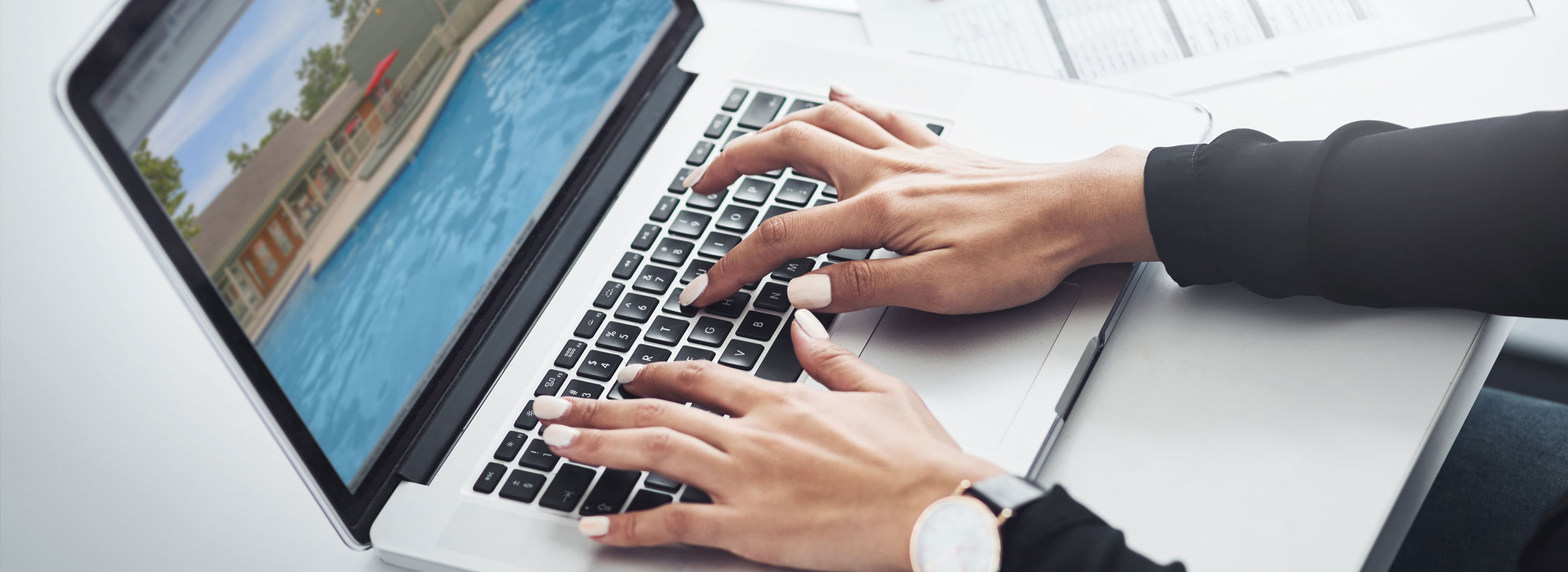 woman typing on laptop keyboard