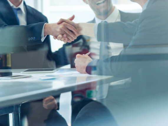 busines team members shaking hands in a conference room