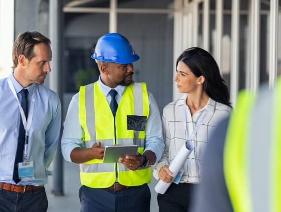 business team members wearing construction vests